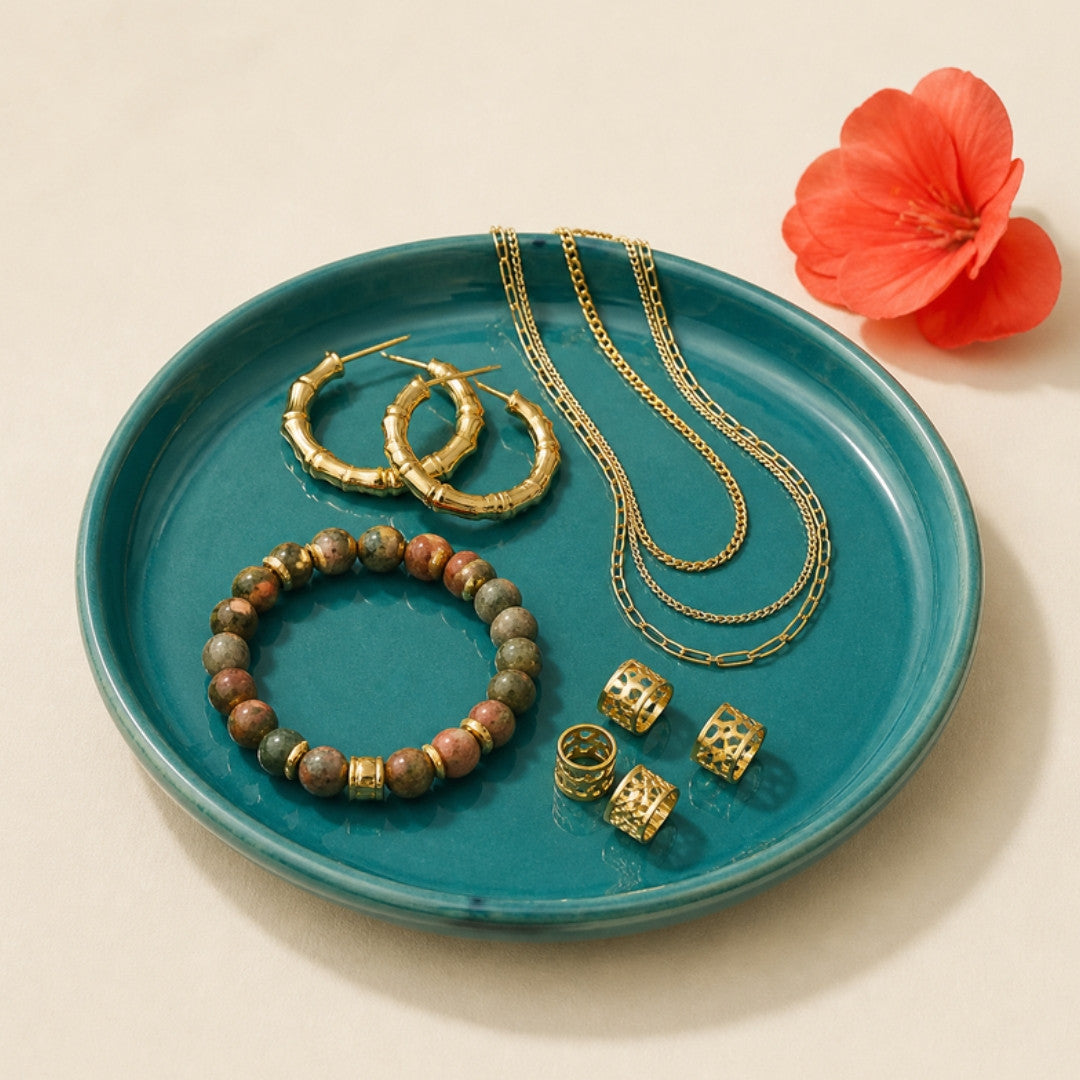 Jewelry: gold hoops, layered chains, beaded bracelet and loc cuffs